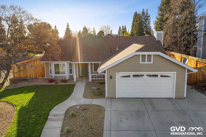 Home exterior featuring Monterey Taupe HardiePlank siding, Arctic White trim, and a landscaped front yard in Folsom, CA