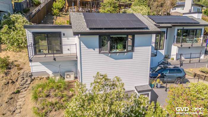 Modern home exterior showcasing Arctic White James Hardie siding, large Anlin Catalina windows, and new balcony in San Rafael