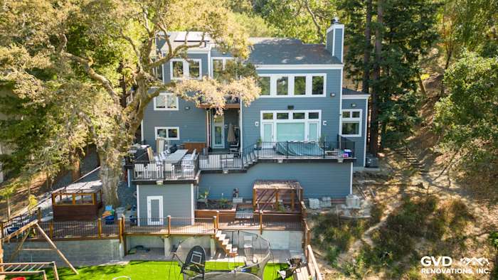 Home exterior featuring James Hardie Night Gray siding and Arctic White trim in Orinda, CA, with a deck and landscaped yard