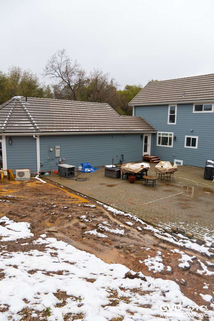 Sutter Creek home exterior showcasing new Boothbay Blue James Hardie siding and patio area with furniture