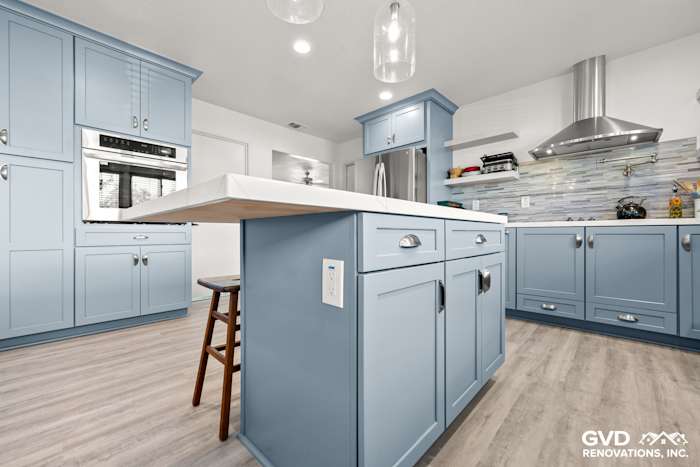 Bright blue Waypoint cabinets and MSI Calacatta Ultra countertops in a remodeled Elk Grove kitchen, featuring a modern design