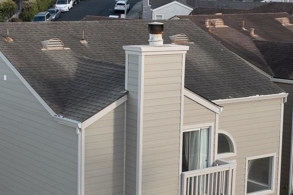 Daly City home featuring James Hardie Lap Siding in Monterey Taupe and Cobble Stone trim, mountain backdrop