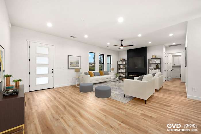 Open-concept living area featuring high ceilings, large windows, and modern decor in new construction home, Paradise, CA