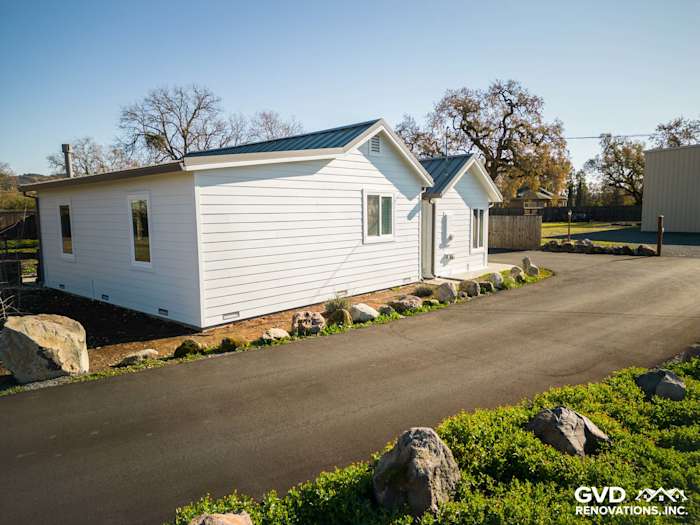 Home exterior featuring James Hardie siding in Arctic White, freshly installed with a landscaped yard in Sonoma, CA