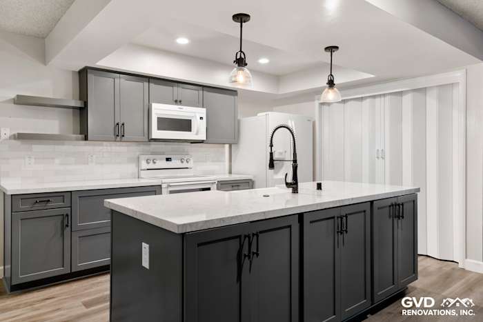 Modern kitchen remodel featuring gray cabinets, quartz countertop, and pendant lighting in Sacramento