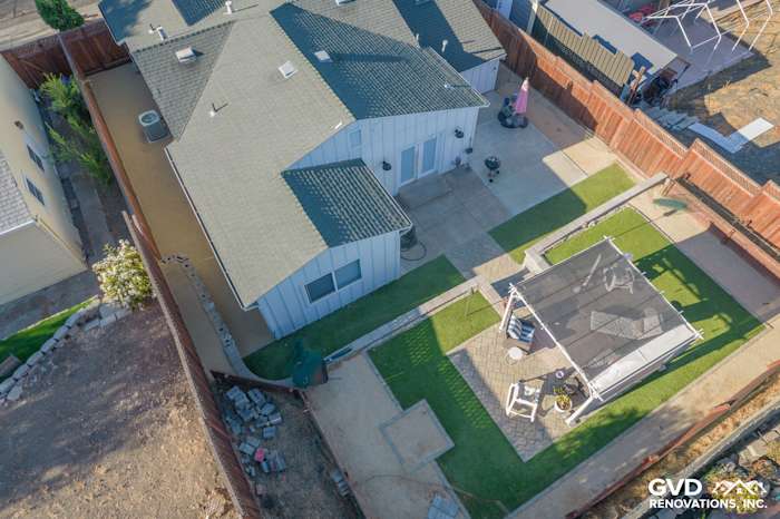 Aerial view of a home in Concord, CA, featuring Arctic White Vertical Siding and a landscaped backyard with a patio