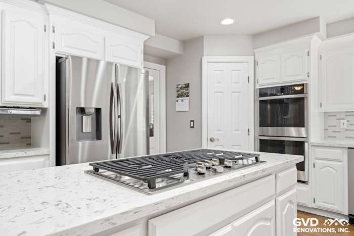 White kitchen with quartz countertops, stainless steel appliances, and modern cabinetry in Fair Oaks renovation