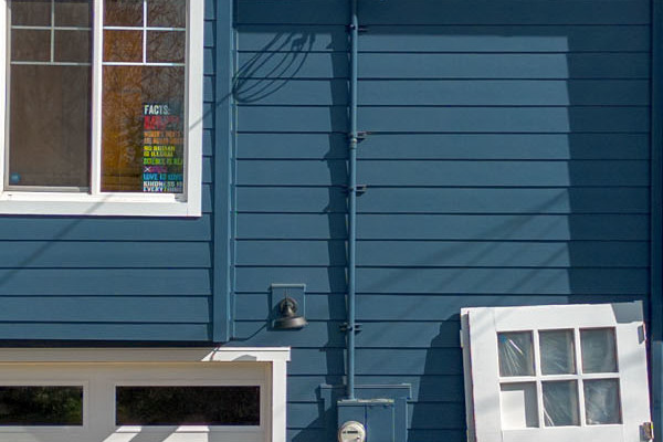 Bold James Hardie Evening Blue siding with Arctic White trim on a renovated Oakland home exterior