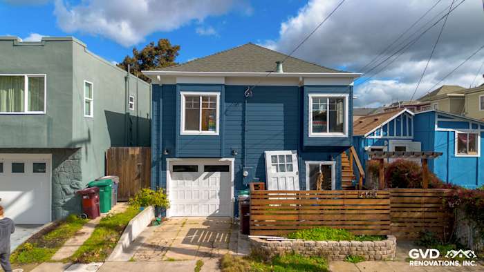 Bold James Hardie Evening Blue siding with Arctic White trim on a renovated Oakland home exterior