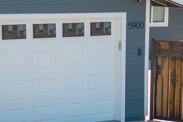 Home exterior featuring James Hardie Lap Siding in Night Gray and Arctic White trim, with a new garage door