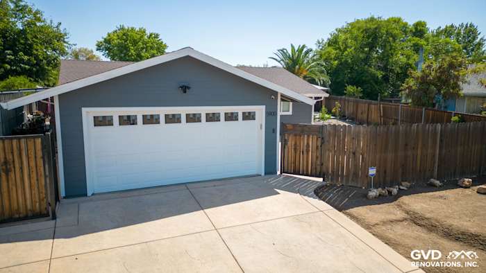 Home exterior featuring James Hardie Lap Siding in Night Gray and Arctic White trim, with a new garage door