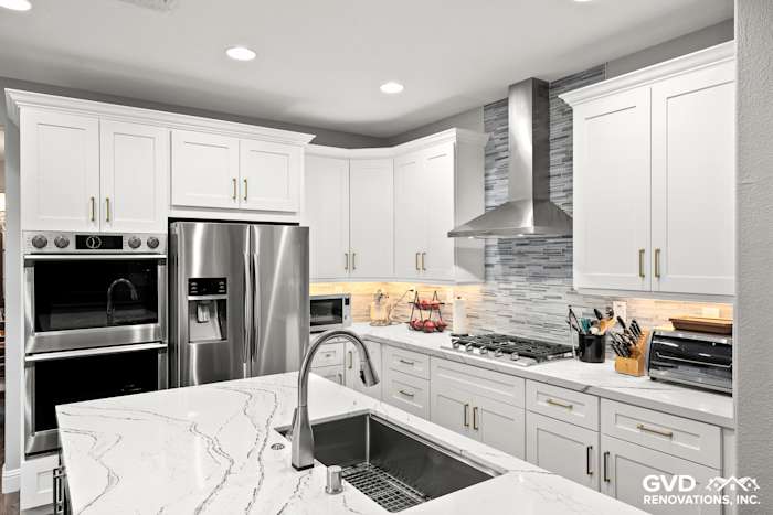 Modern kitchen remodel in Roseville featuring Cambria countertops, white cabinetry, stainless steel appliances, and subway