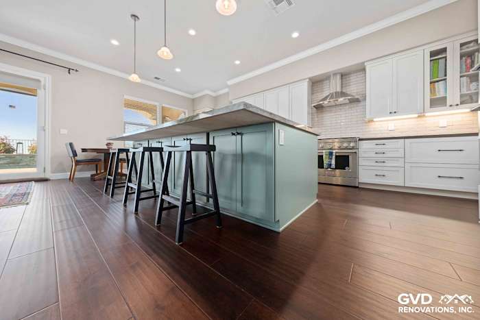 Modern kitchen with an island, white cabinets, quartz countertops, and dark hardwood flooring in El Dorado Hills
