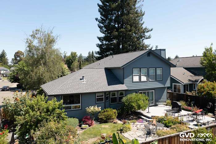 Home exterior featuring new Boothbay Blue James Hardie siding and Milgard windows surrounded by landscaping in Rohnert Park