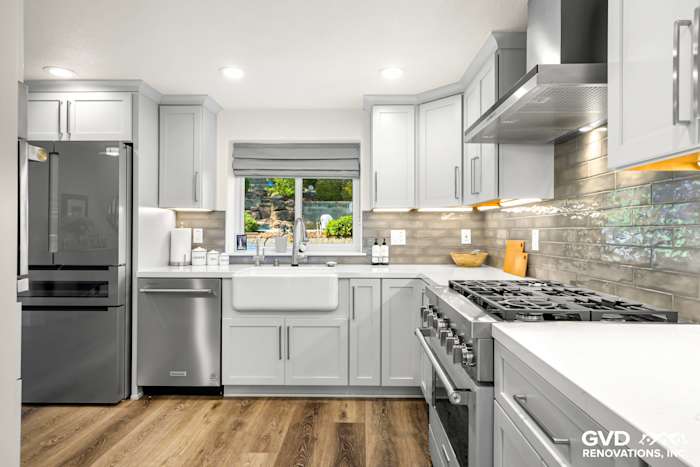 Modern kitchen remodel in Rocklin with gray cabinets, farmhouse sink, quartz countertops, and stainless steel appliances