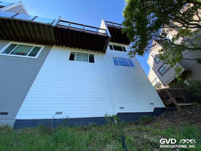 Newly installed pre-finished James Hardie lap siding on home exterior in Mill Valley, showcasing white and gray tones