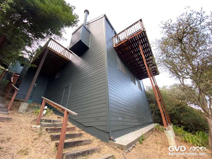 Dark green James Hardie siding on modern home exterior with two elevated decks in Mill Valley, CA