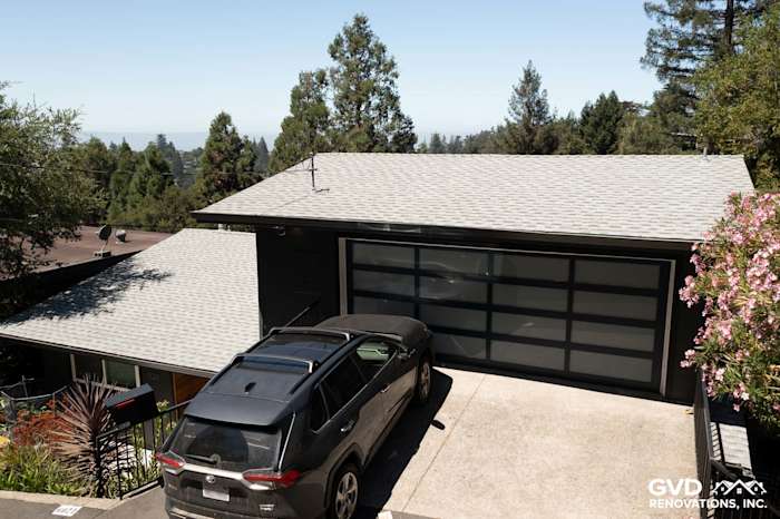 Home exterior in Oakland featuring James Hardie Iron Gray siding and modern garage door with a driveway