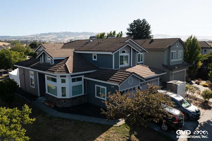 Home exterior in Petaluma showcasing James Hardie lap siding in Night Gray and Pearl Gray shingle accents with rustic trim