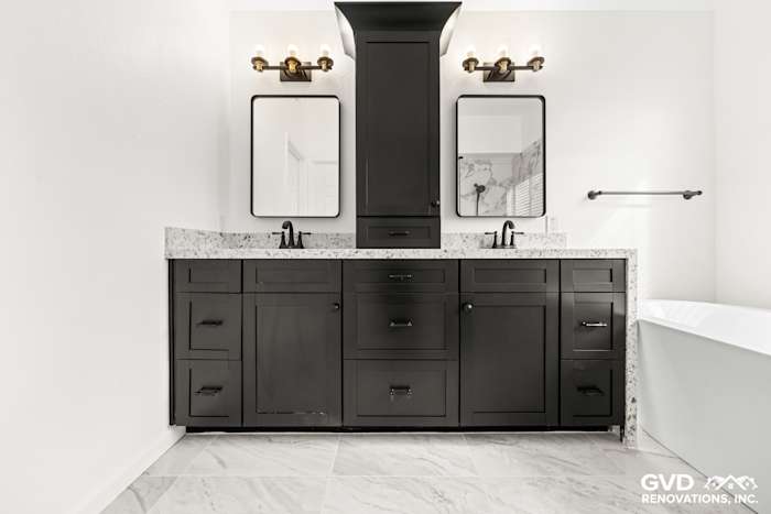 Modern double sink vanity with custom black cabinetry and white quartz countertop in remodeled Sacramento bathroom