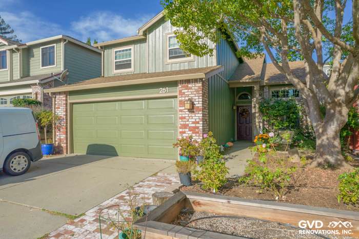 House exterior showcasing Mountain Sage James Hardie siding, brick accents, and a landscaped front yard in Vallejo