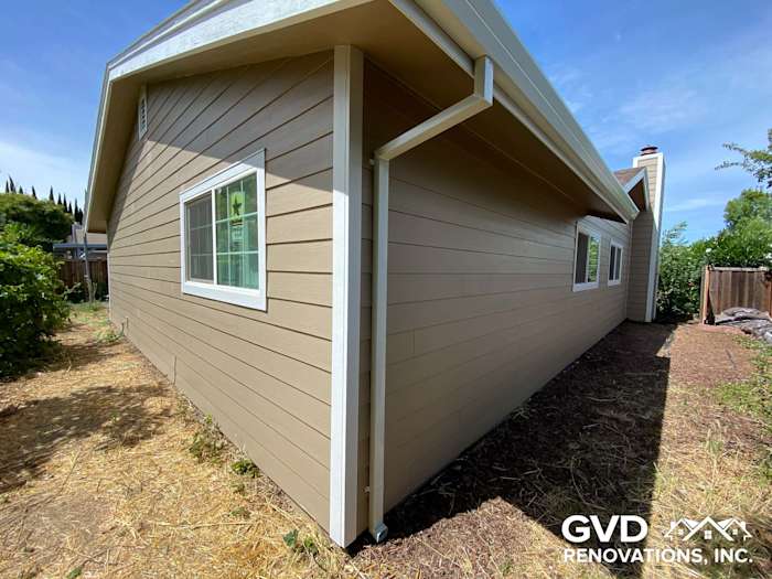 New James Hardie lap siding in Khaki Brown with Arctic White trim on home exterior in Fairfield, CA