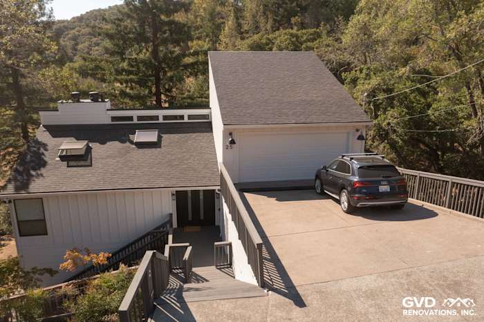 Home exterior in Novato featuring new Arctic White James Hardie siding with a modern roof and driveway