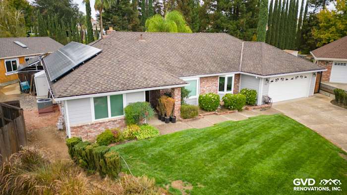 Updated home exterior featuring James Hardie Cedarmill siding, Milgard windows, and a well-maintained lawn in Roseville