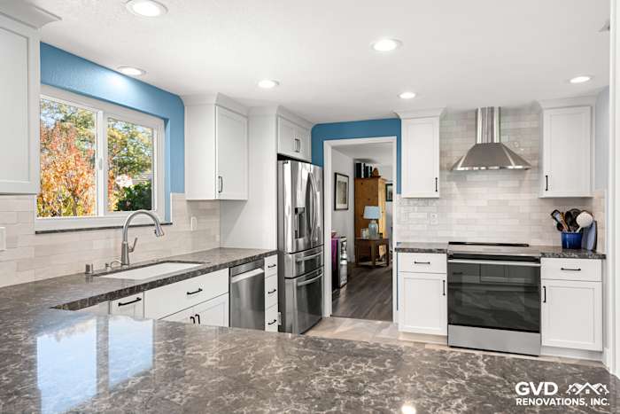 Modern kitchen remodel in Fair Oaks featuring white cabinets, gray quartz countertops, and stainless steel appliances