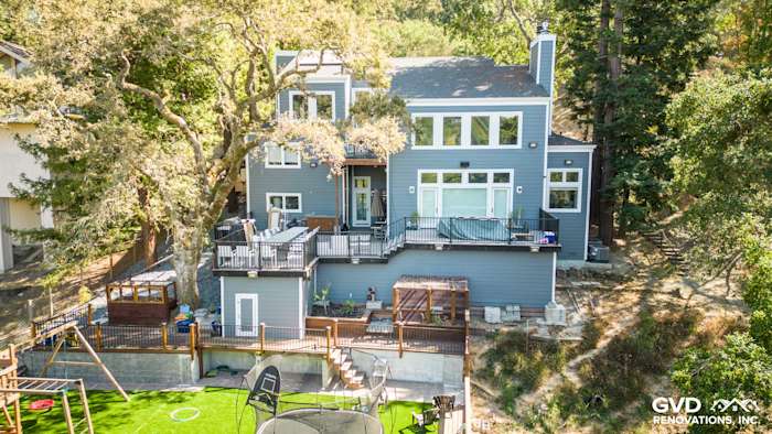 Orinda home with James Hardie Night Gray siding and Arctic White trim, featuring a spacious deck and backyard play area