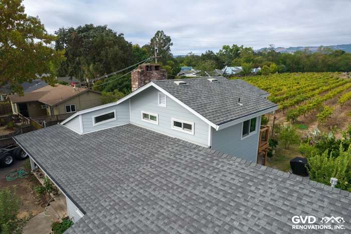 Elevated view of a Sonoma home featuring Light Mist James Hardie siding and gray shingles against vineyard backdrop