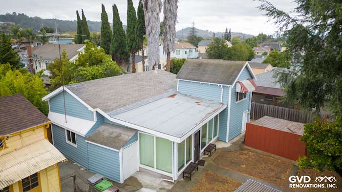 Two-story home in Oakland with newly installed blue Alside Prodigy vinyl siding and large windows