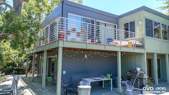 Lafayette home exterior featuring James Hardie Night Gray siding, modern railings, and outdoor seating area