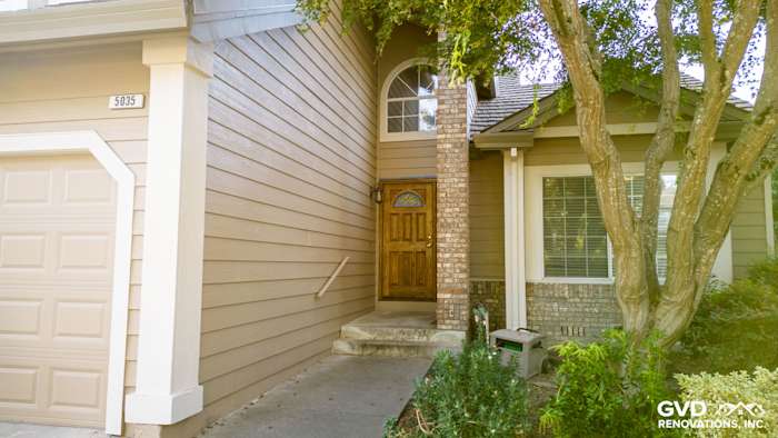 Khaki brown James Hardie lap siding, Alside vinyl windows, and brick accents on home entry in Santa Rosa