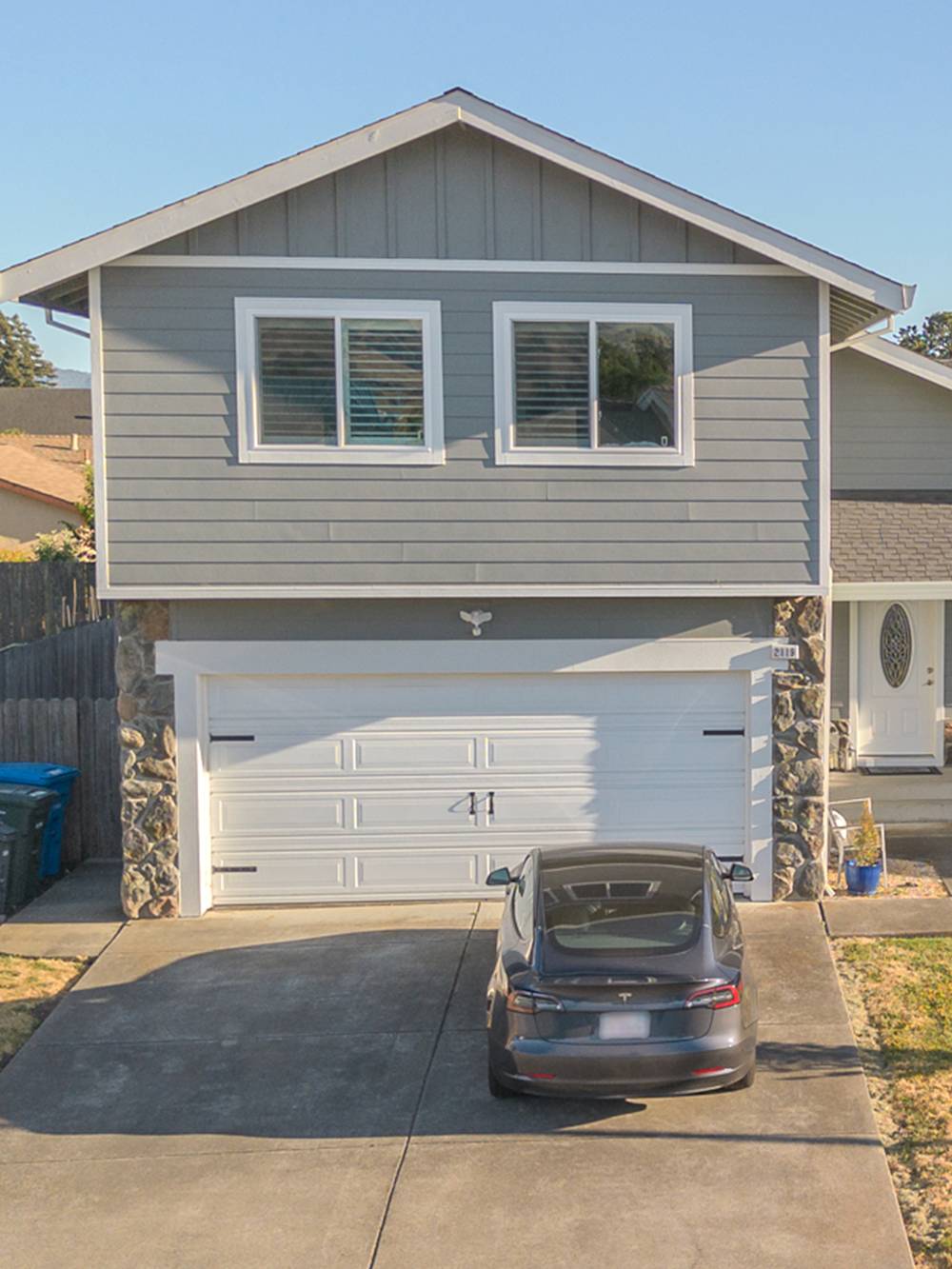 Updated home exterior featuring modern grey siding and fresh design elements