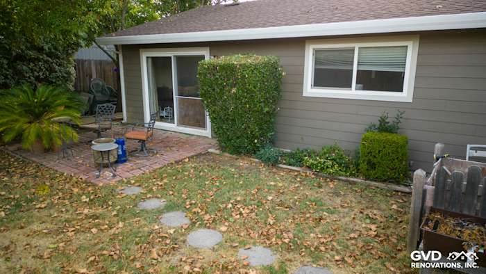 New Cobble Stone James Hardie siding installed on home exterior with landscaped patio and stone pathway in Orangevale