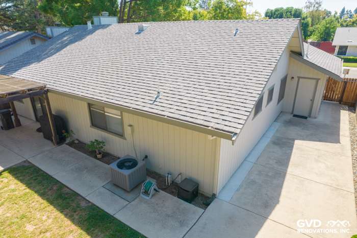 Modern home exterior featuring James Hardie Siding, gray roof, and landscaped yard in Sacramento