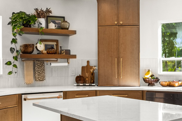 Modern kitchen in Fair Oaks featuring curved cabinets, quartz island, stainless steel appliances, and ample natural light