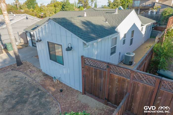 Modern home exterior featuring Arctic White Vertical Siding and trim, with a dark green roof in Concord, CA