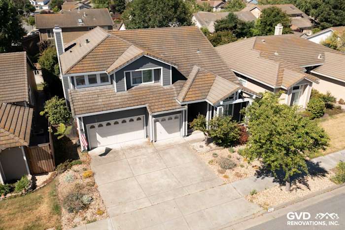 Home exterior in Petaluma showcasing Night Grey James Hardie siding and Arctic White trim with new vinyl windows