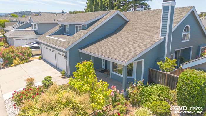 Foster City home featuring James Hardie Boothbay Blue siding and Arctic White trim with landscaped front yard