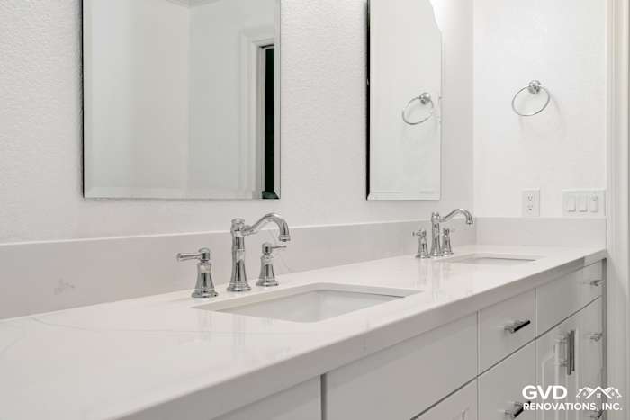 Bright bathroom with double sinks, quartz countertop, sleek chrome fixtures, and modern mirrors in Fair Oaks, CA