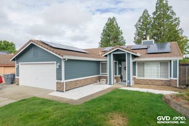 Home exterior featuring James Hardie Evening Blue siding, Arctic White trim, and Eldorado Stone accents in Rocklin, CA
