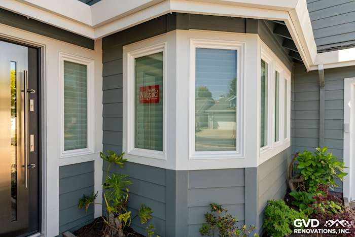Boothbay Blue HardiePlank siding with Arctic White trim and Milgard windows on a home exterior corner