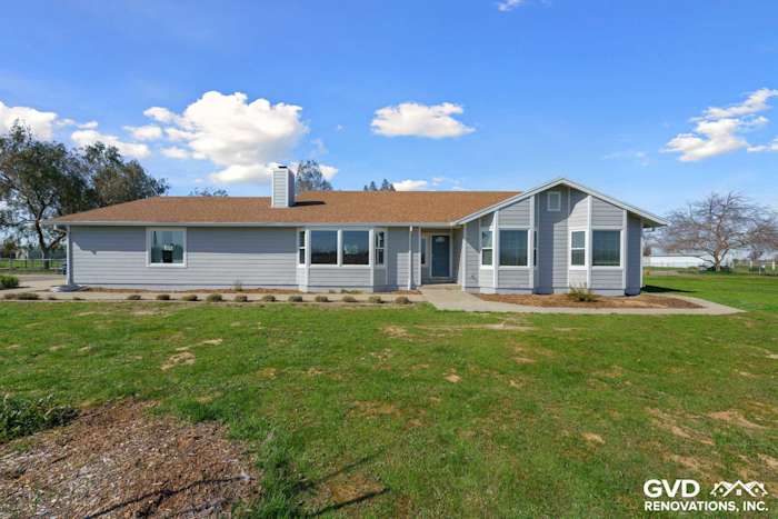 Home exterior showcasing Pearl Gray James Hardie siding, Arctic White trim, and new Anlin windows in Galt, CA