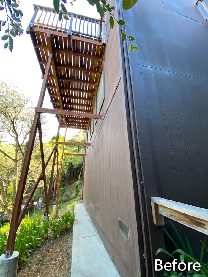 Before shot of Mill Valley home showing James Hardie siding, wooden deck, and sloped landscaping