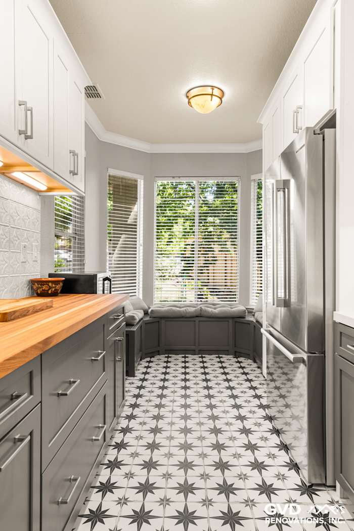 Modern Folsom kitchen remodel featuring gray cabinetry, wood countertops, and star-patterned tile flooring