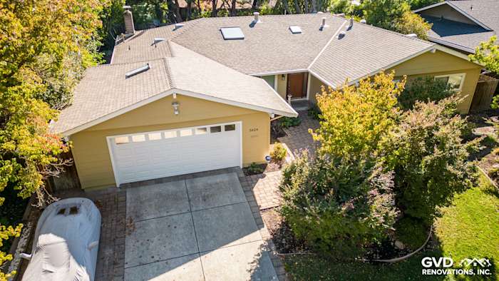 Carmichael home exterior showcasing James Hardie siding and landscaping, featuring a garage and patio area