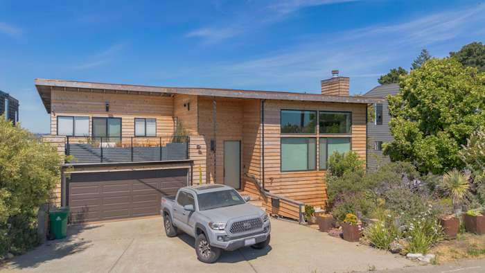 Natural cedar beveled plank siding on a modern home exterior with new deck railings in Richmond, CA