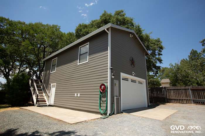 Auburn home's exterior showcasing Aged Pewter HardiePlank siding and Arctic White trim with a garage